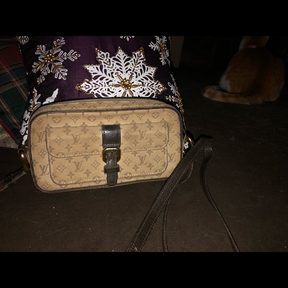 A small  beige canvas crossover LV .